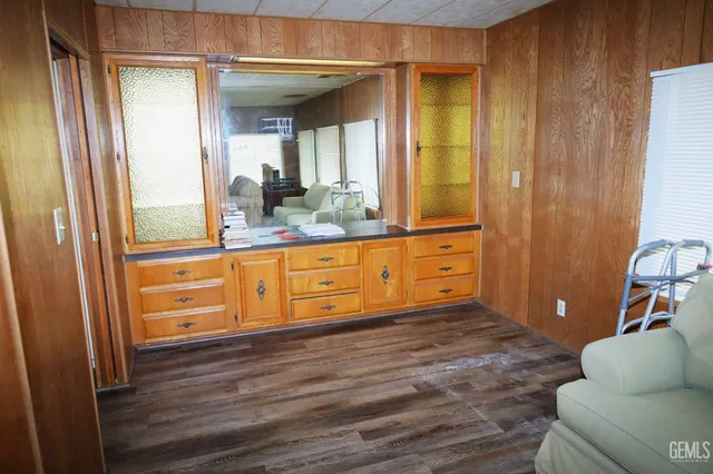 a kitchen with a sink stove and wooden floor