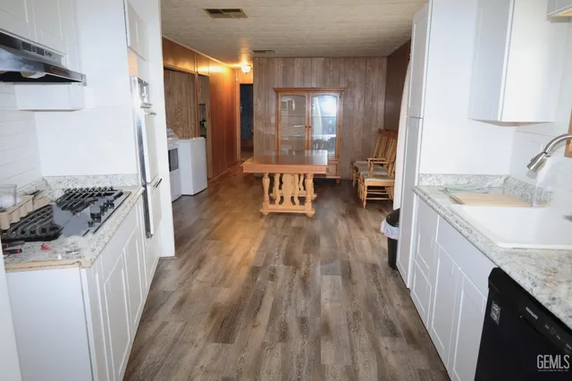 a view of kitchen island with furniture and wooden floor