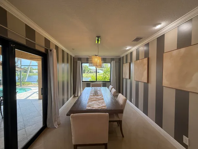 a view of a hallway with furniture and window