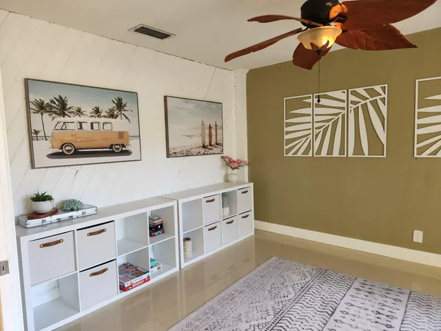 a view of a bedroom with furniture and fan