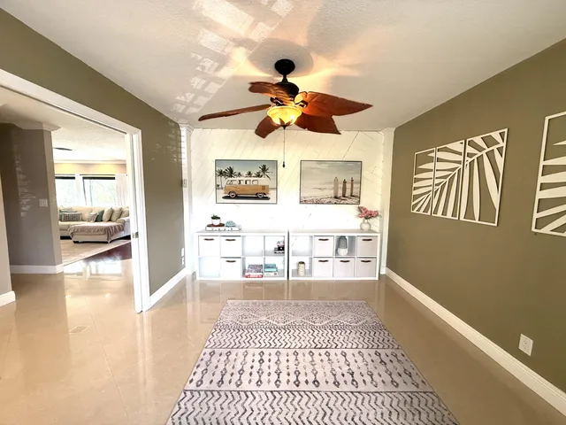 a living room with stainless steel appliances furniture and a rug