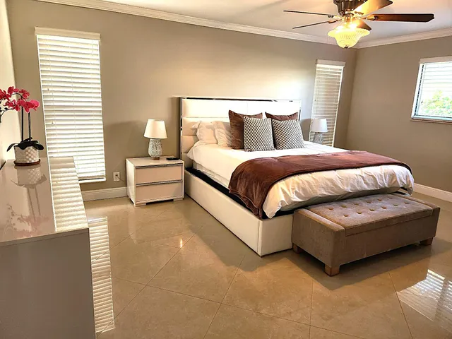 a spacious bedroom with a bed and a chandelier