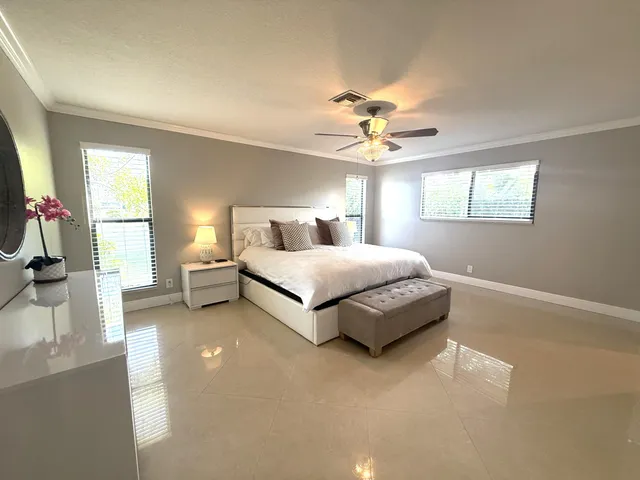a large bedroom with a bed and a chandelier