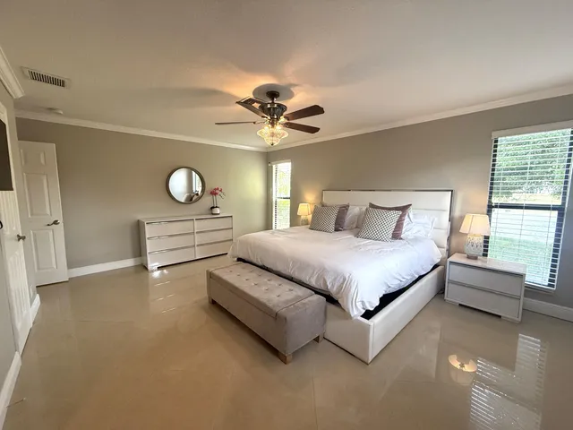 a spacious bedroom with a bed and window