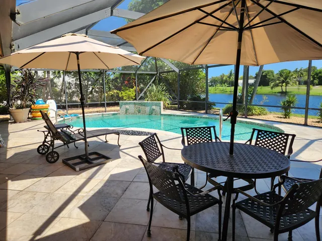 a view of wooden chairs and table in the patio