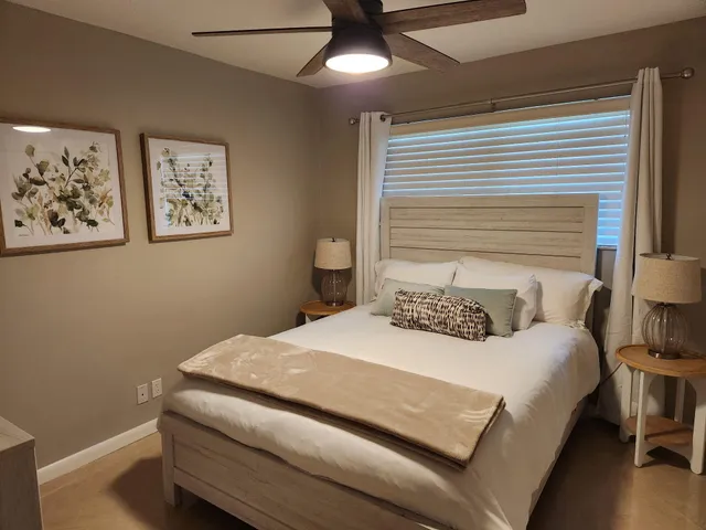 a bedroom with a bed and a chandelier