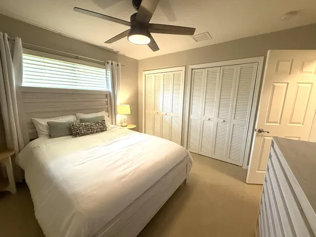 a large bed sitting in a bedroom next to a window