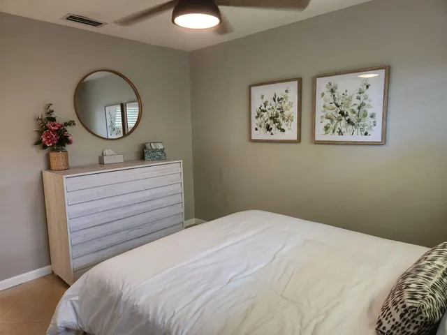 a bedroom with a bed and a mirror