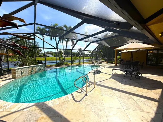 a view of a swimming pool with a patio