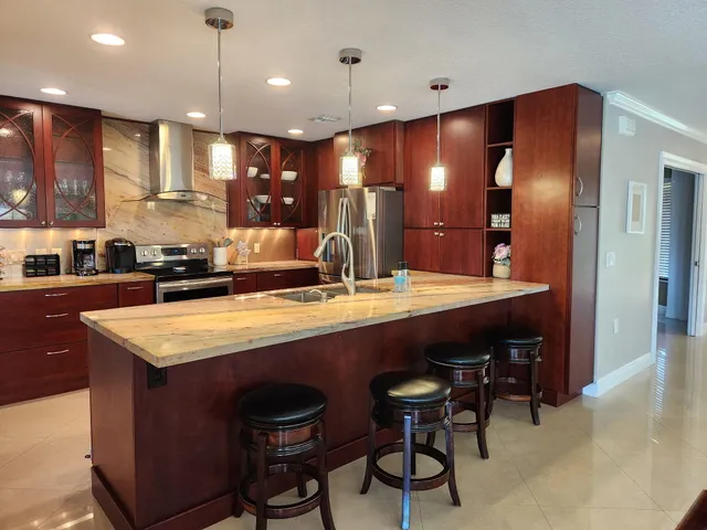 a large kitchen with a table and chairs
