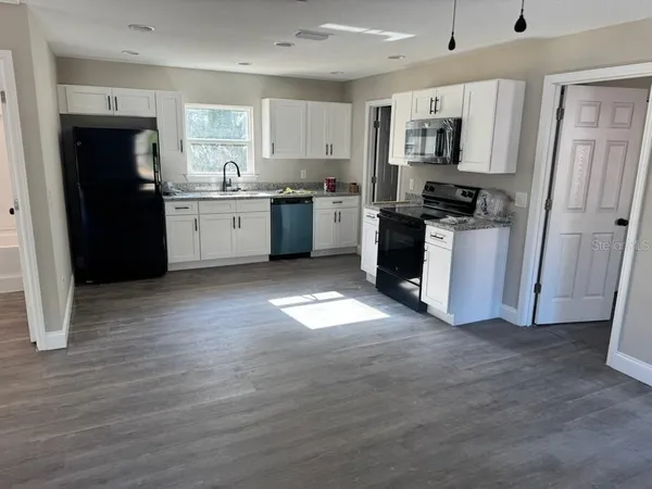 a kitchen with stainless steel appliances a refrigerator stove and sink