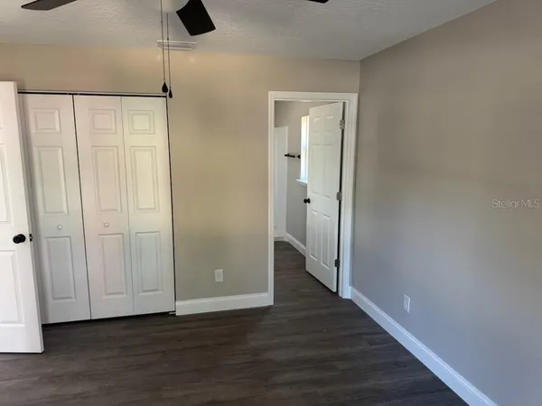 a view of an empty room with wooden floor