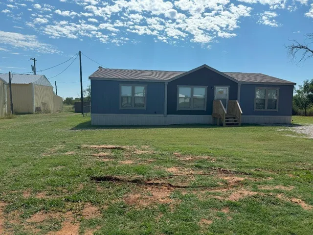 a front view of a house with yard