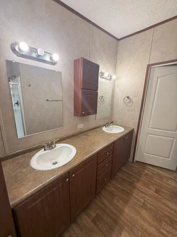 a bathroom with a double vanity sink and a mirror