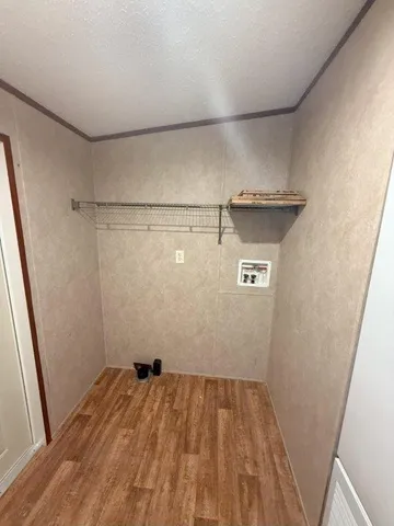 a view of a room with wooden floor