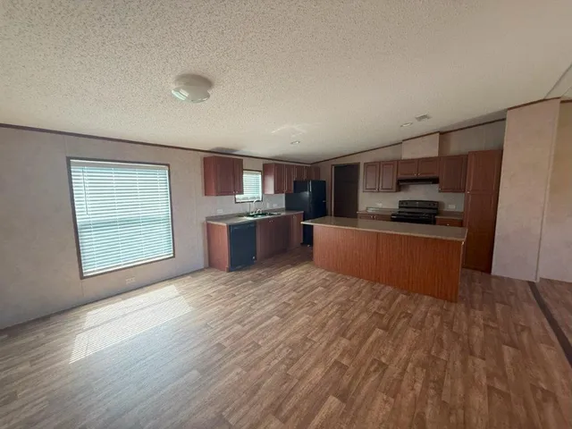 a large kitchen with cabinets and stainless steel appliances