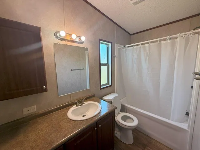 a bathroom with a toilet a sink and a mirror