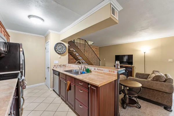 a kitchen with a sink appliances and cabinets