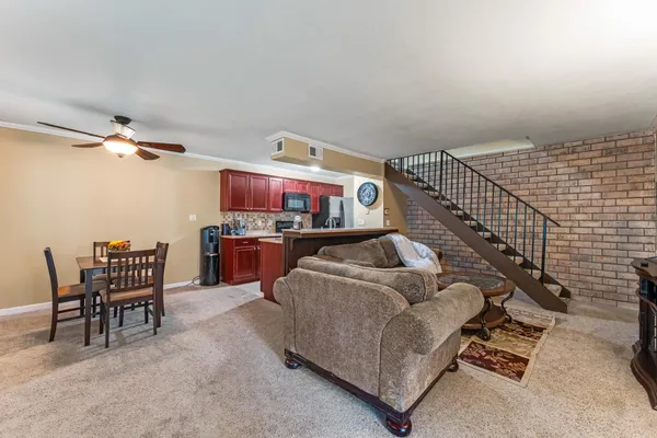 a living room with furniture and kitchen view