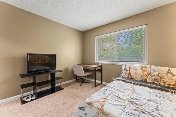 a bedroom with a bed and a window