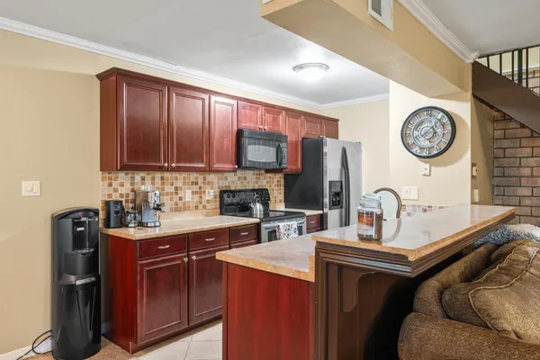 a kitchen with a sink cabinets and appliances