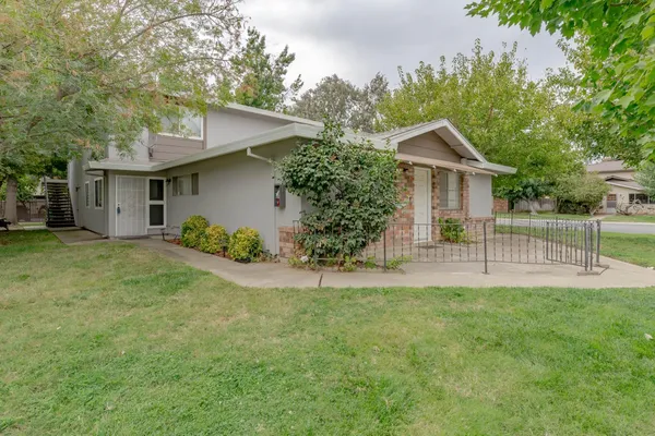 a view of a house with a yard and a garden
