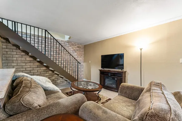 a living room with furniture or flat screen tv and a fireplace