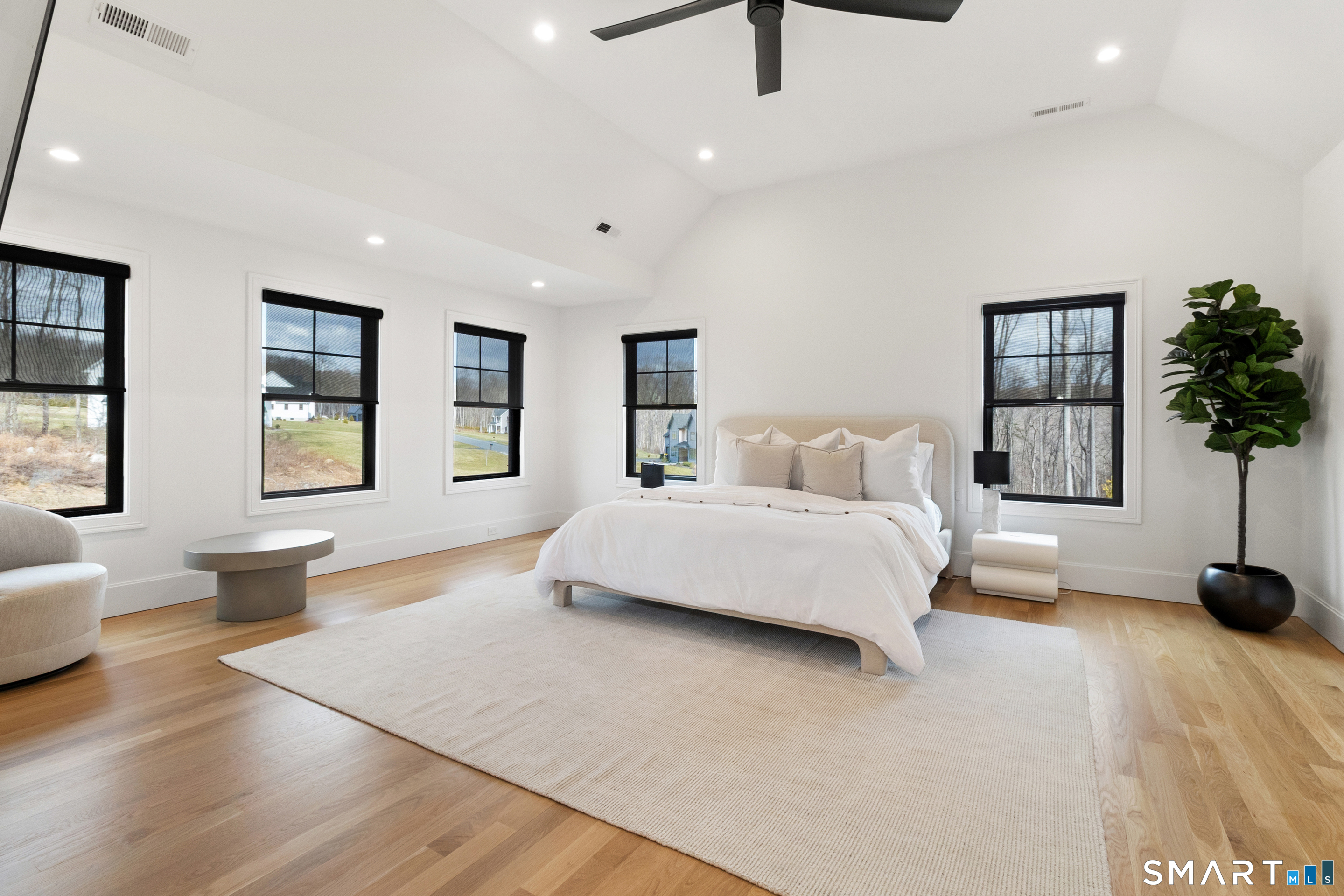 8 Holly Lane Newtown, CT 06482 - Photo 18 of 36 a spacious bedroom with a large bed and a couch