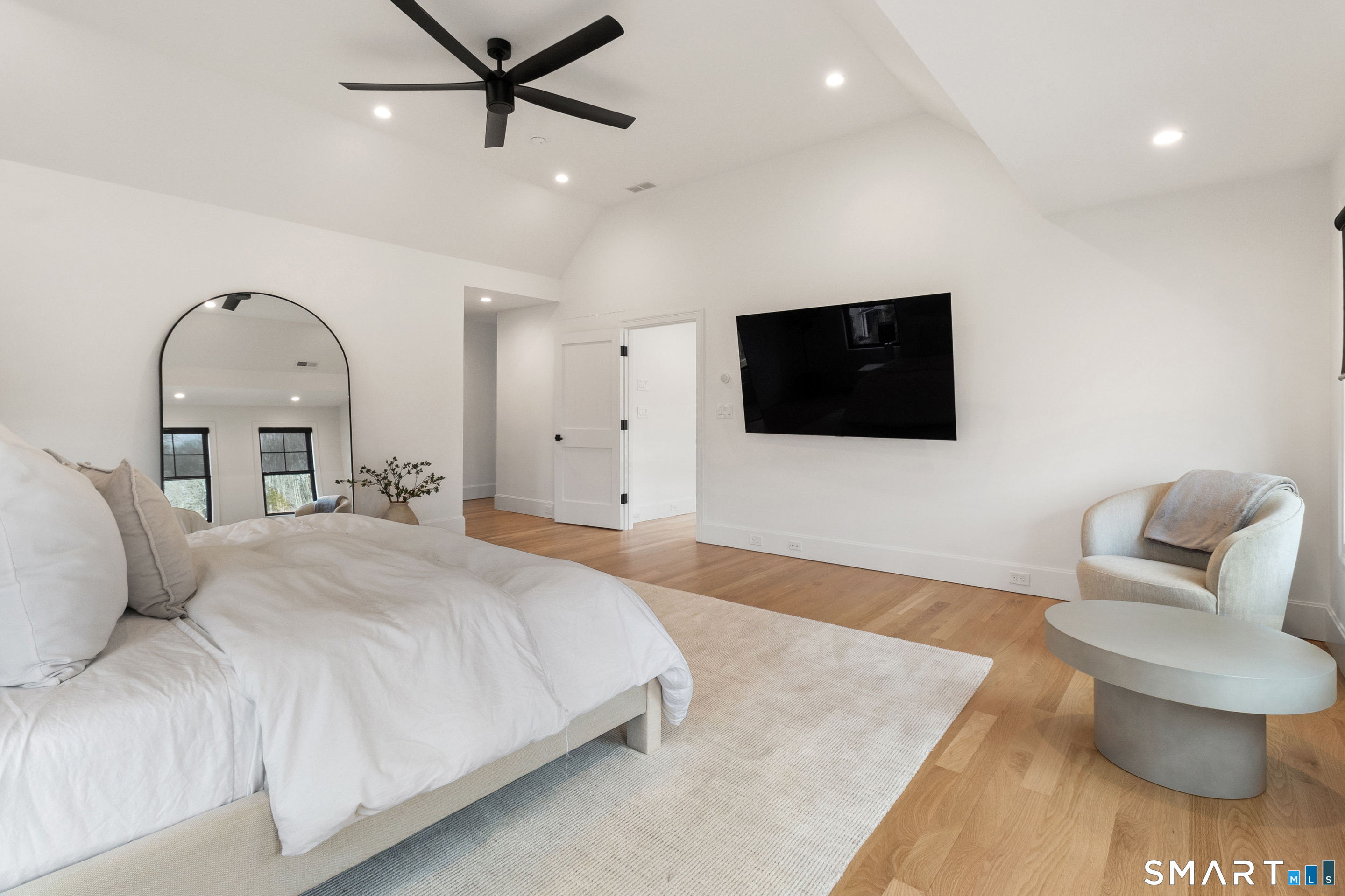 8 Holly Lane Newtown, CT 06482 - Photo 19 of 36 a bedroom with a bed and a flat screen tv