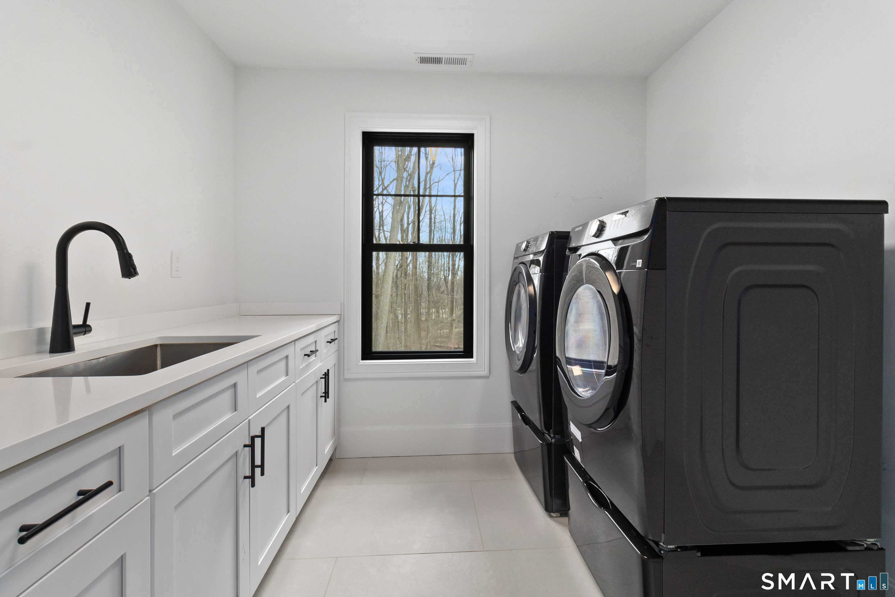 8 Holly Lane Newtown, CT 06482 - Photo 27 of 35 a utility room with sink dryer and washer
