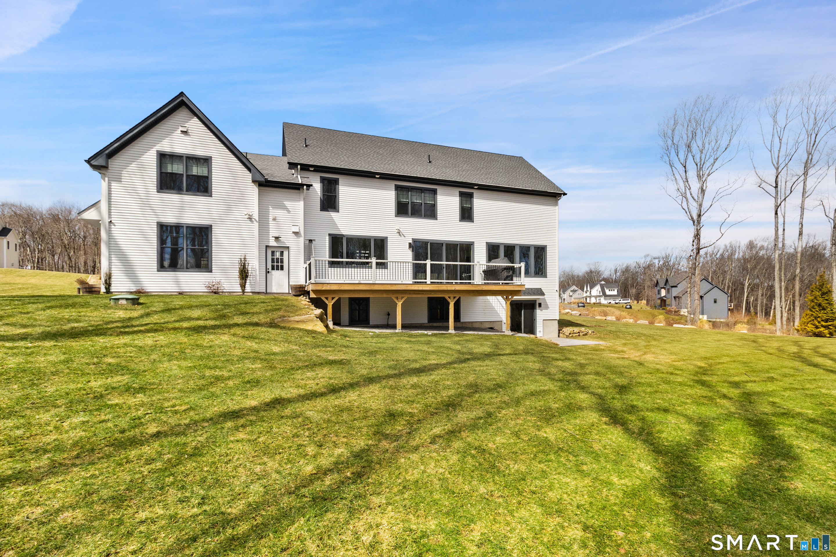 8 Holly Lane Newtown, CT 06482 - Photo 32 of 36 a front view of residential houses with yard and trees
