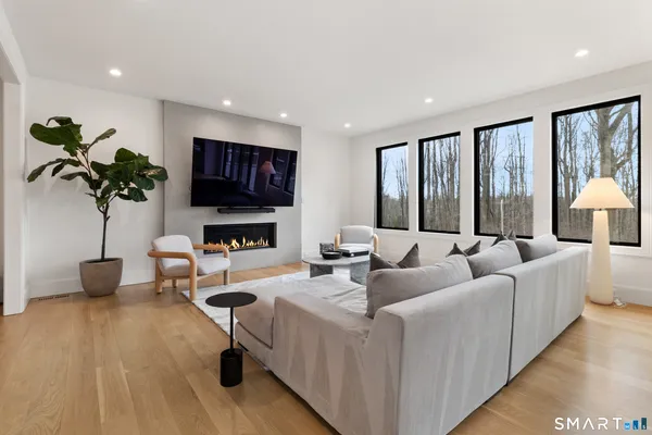 a living room with furniture and a wooden floor