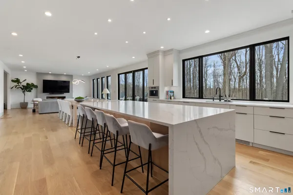 a large white kitchen with stainless steel appliances