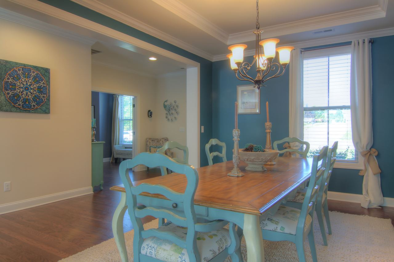 8333 Henderson Road Apex, NC 27539 - Photo 4 of 25 Perfectly situated off the kitchen and family room, this dining room is one you will actually use (and your dining room table with the extra leaf will fit)! Dining Room