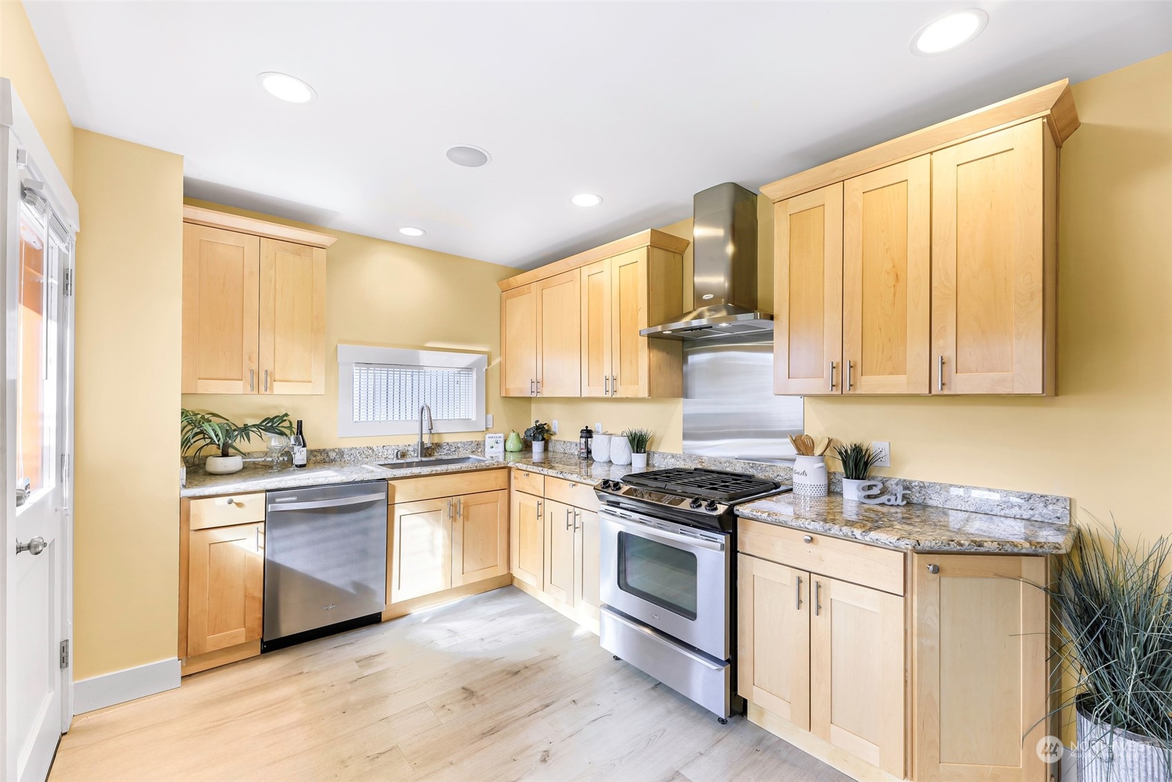 6023 44th Avenue Southwest Seattle, WA 98136 - Photo 13 of 32 a kitchen with stainless steel appliances granite countertop a stove a sink and a refrigerator