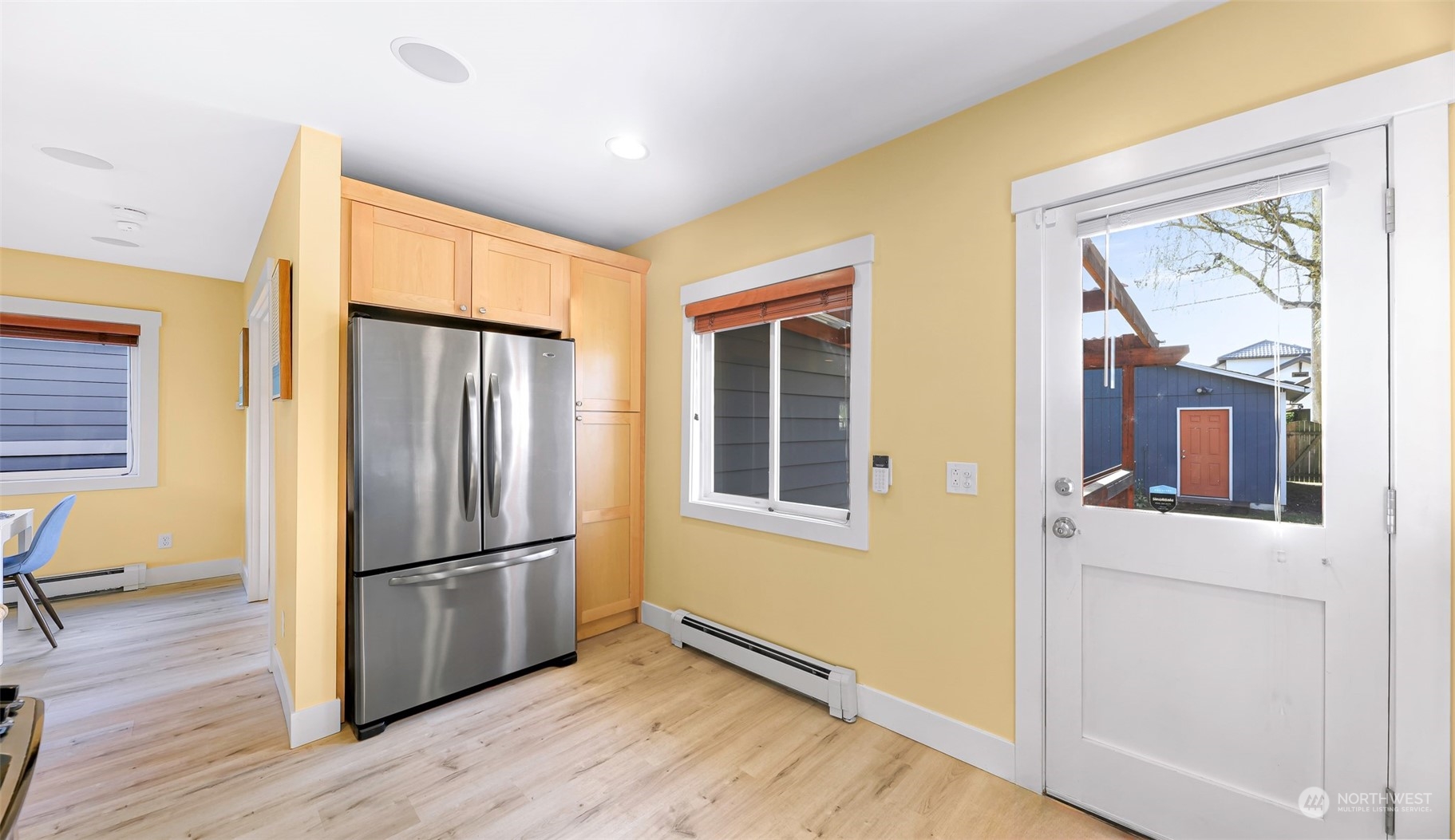 6023 44th Avenue Southwest Seattle, WA 98136 - Photo 18 of 32 a view of a refrigerator in kitchen and wooden floor