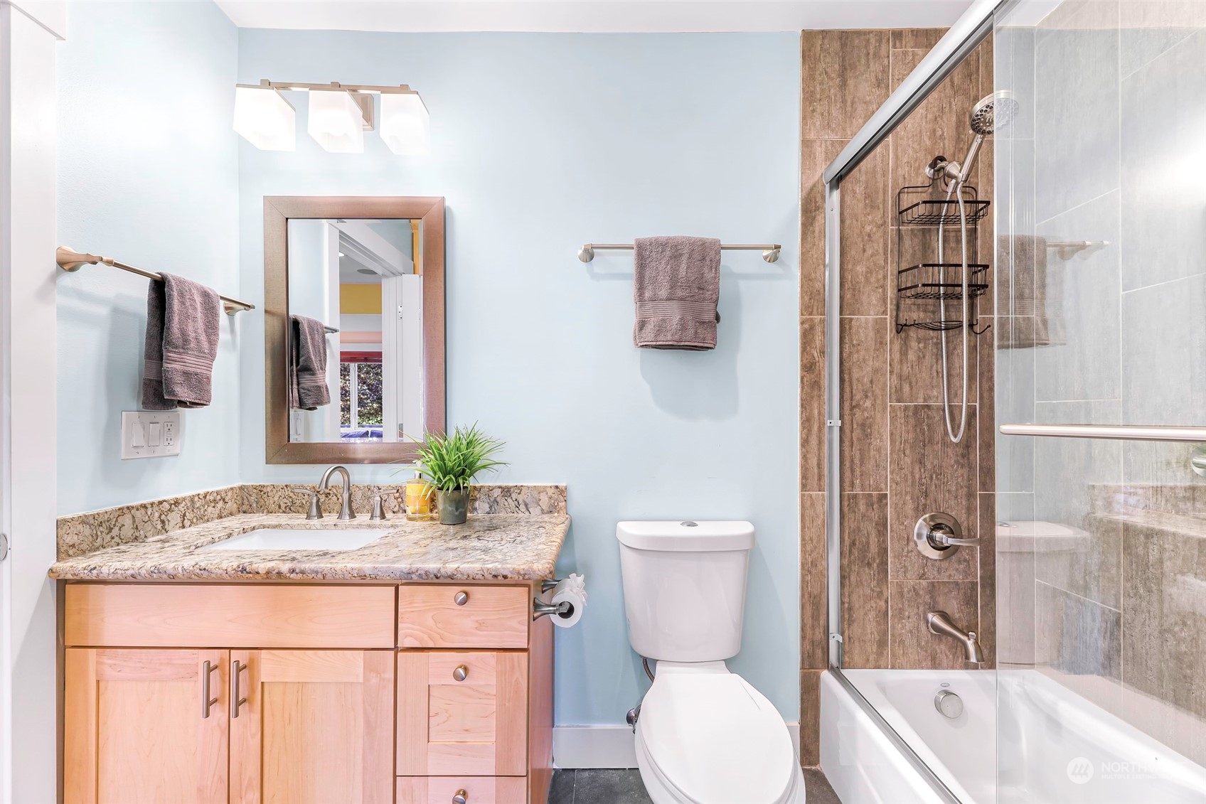 6023 44th Avenue Southwest Seattle, WA 98136 - Photo 23 of 32 a bathroom with a granite countertop sink toilet and shower