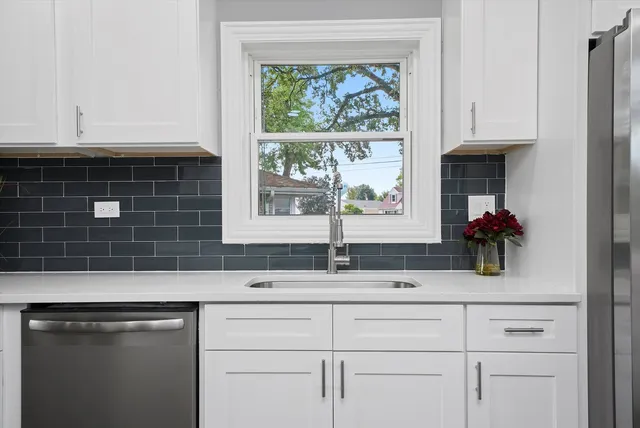 a kitchen with sink cabinets and wooden floor