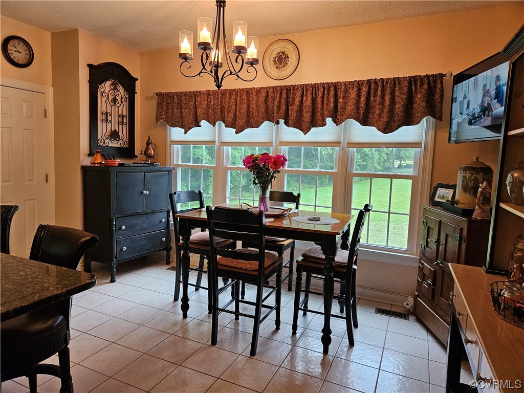 6373 Pine Slash Road Mechanicsville, VA 23116 - Photo 11 of 49 a view of a dining room with furniture window and wooden floor