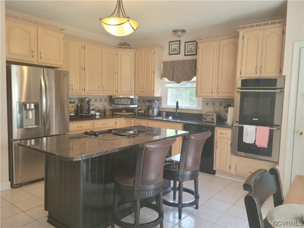 6373 Pine Slash Road Mechanicsville, VA 23116 - Photo 12 of 49 a kitchen with stainless steel appliances granite countertop a sink a stove and a refrigerator