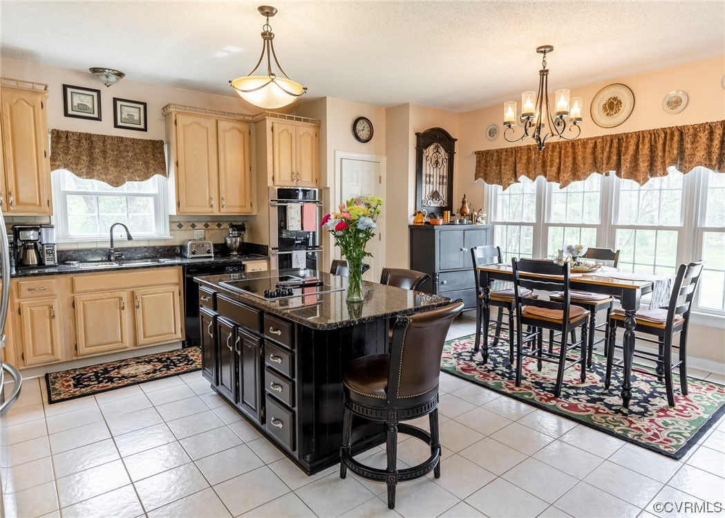 6373 Pine Slash Road Mechanicsville, VA 23116 - Photo 13 of 49 a kitchen with stainless steel appliances granite countertop a stove a sink dishwasher a dining table and chairs with wooden floor