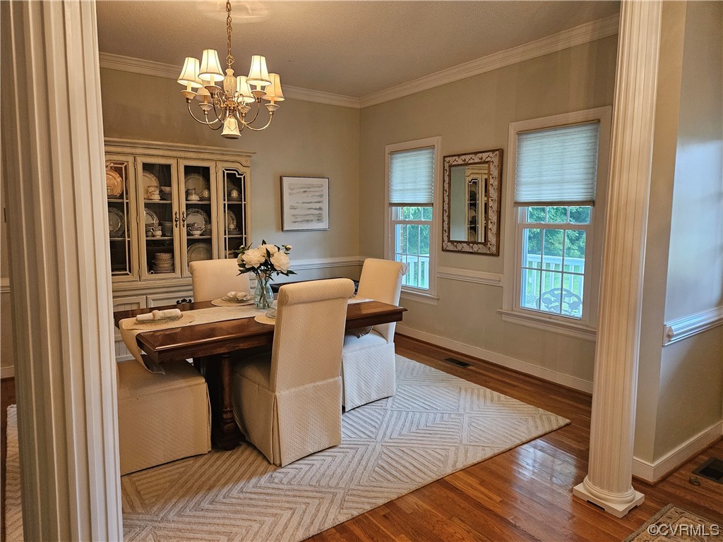 6373 Pine Slash Road Mechanicsville, VA 23116 - Photo 8 of 49 a dining room with chandelier and wooden floor