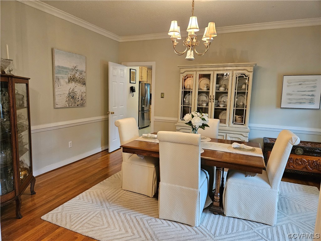 6373 Pine Slash Road Mechanicsville, VA 23116 - Photo 9 of 49 a view of a dining room with furniture wooden floor and chandelier