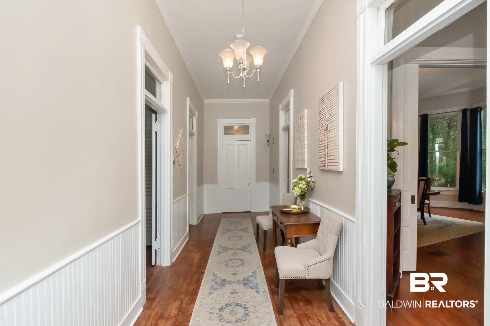 1305 Brown Street Mobile, AL 36604 - Photo 7 of 37 Hallway with crown molding, an inviting chandelier, and hardwood / wood-style floors
