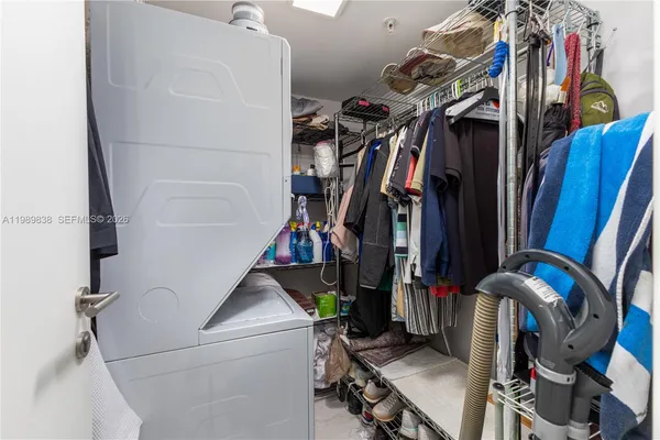 a view of walk in closet with clothes