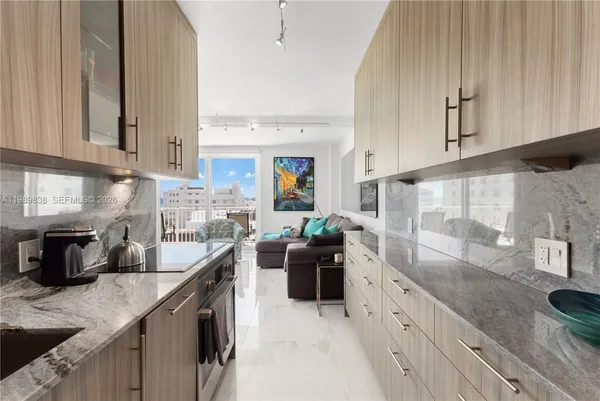 a kitchen with stainless steel appliances granite countertop a sink stove and cabinets