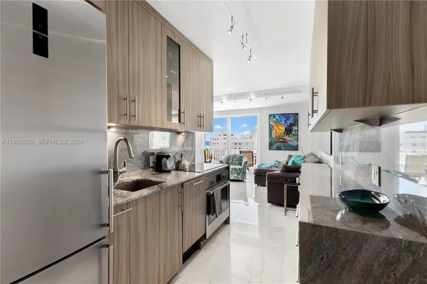 a kitchen with stainless steel appliances granite countertop a sink stove and refrigerator