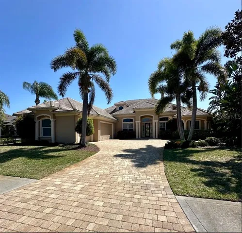 a front view of a house with a yard and trees