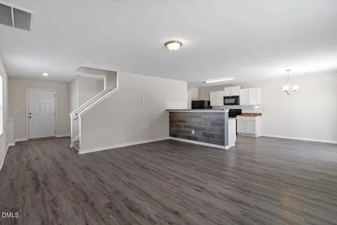 a view of kitchen with wooden floor electronic appliances and window