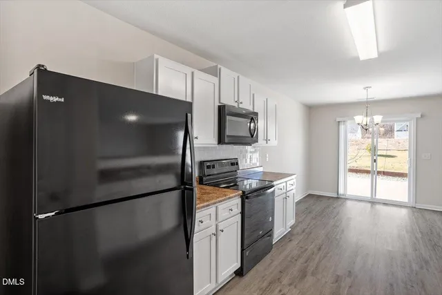 a kitchen with stainless steel appliances a refrigerator and a stove top oven